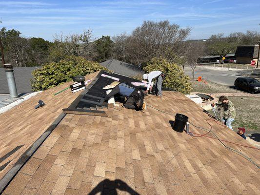 The guys laying shingles