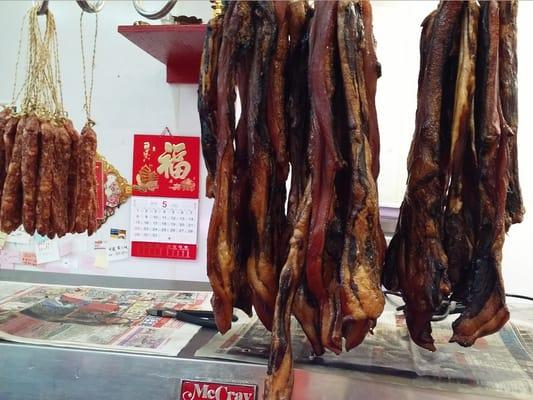 Typical Chinese staple foods, dried sausage & Chinese bacon hanging on hooks.