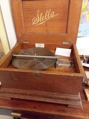 125 year old music box with a variety of metal discs. Staff will change the song upon request.