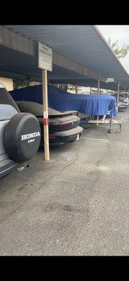 Abandoned cars in parking. Owner users parking lot as personal storage and has multiple boats parked there.