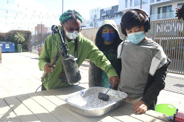 Students interacting with different materials to create foley for their videos