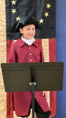 Students in fourth grade give presentations about colonial America.