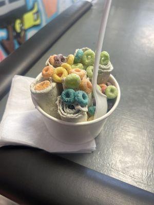 Captain crunch rolled ice cream with fruit loops cereal topping.