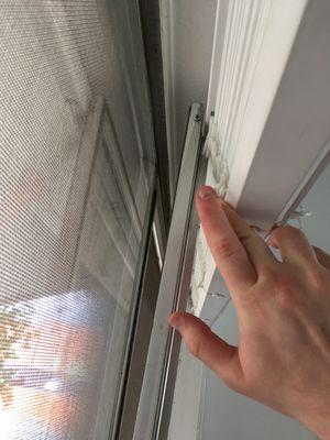 Photo of front room window falling out of its frame. Never repaired.