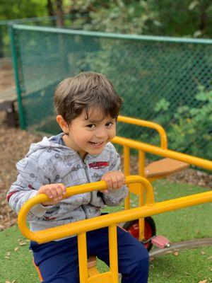 Exploring the large muscle equipment on our playground.