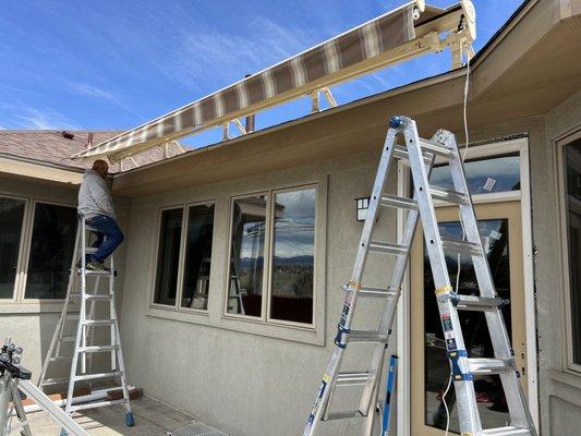 Installed Sunesta beige frame motorized retractable awning with smart case,smart-drop