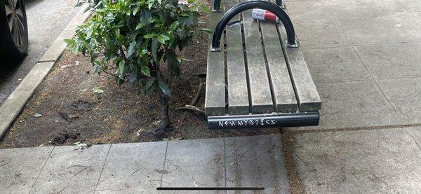 11th street green space - trashed - grafitti on benches