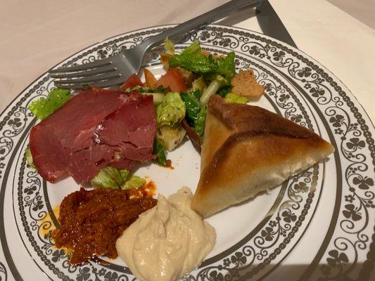 Fattoush salad, min spinach pie, hummus, basterma (Middle Eastern pastrami), and red chili bean dip