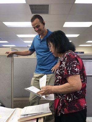 Corey Lohmiller and Carol Ann Baretto reviewing documentation.