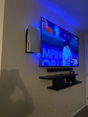 Floating shelf, wireless soundbar, 65inch tv, and mounted ps5