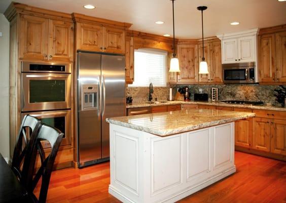 Knotty alder with glaze kitchen- white toned and glazed raised paneled Island - chiseled granite countertops- Brazilian Cherr...