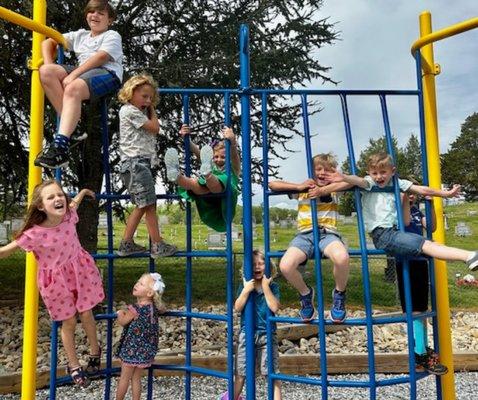 Check out our playground! It's open to the public, fenced to keep your littles safe with tables, benches and shade!