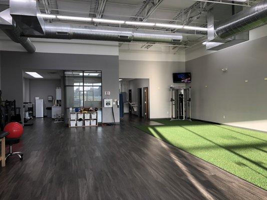 The Performance Rehab Olathe clinic offers an open concept treatment space complete with turf and top of the line equipment.