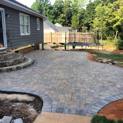 Laying of pavers with two piece pattern and border.