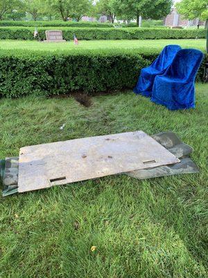 The cemetery sets up four chairs and a tent for the graveside service