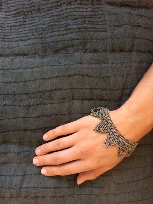 Titanium and 14kt handmade chain mail bracelet and hand printed linen throw.