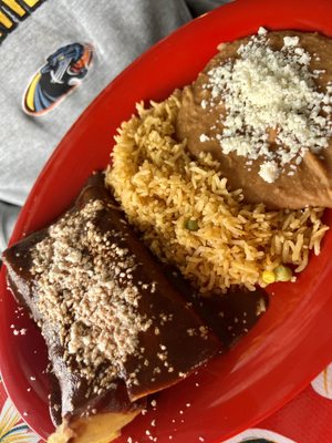 Chicken mole enchiladas, rice and refried pinto beans