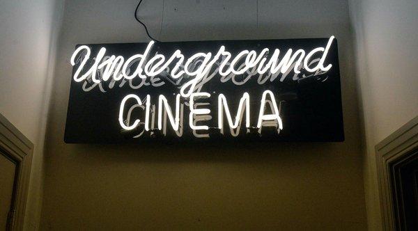 Neon sign guiding you to the Underground Cinema from Taylor Books.