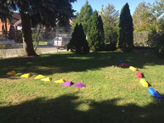 A second playground with green grass where children can get fresh air, smell the flowers and explore!