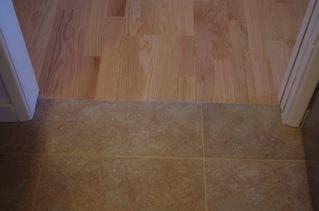 A clean edge between tile and wood floor.