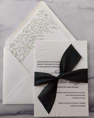 letterpress wedding invitation and custom envelope liner, tied with a silk ribbon