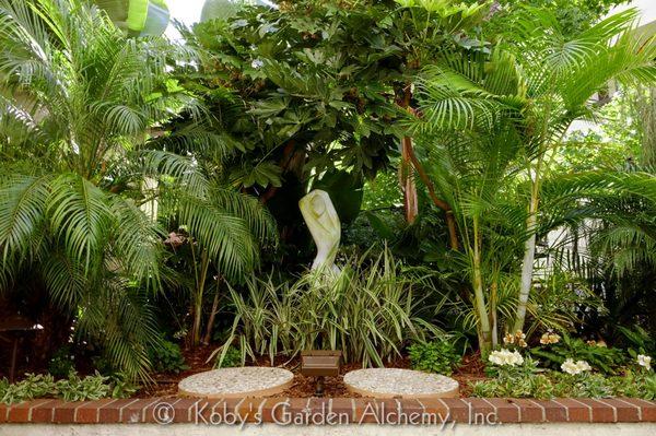 Lushly detailed foliage and a graceful focal point transformed this garden into a sensuous daydream.