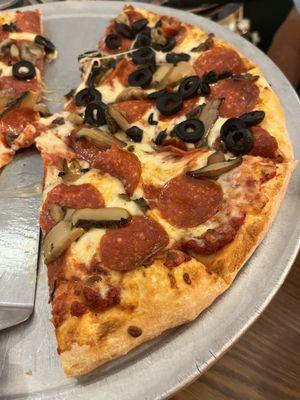 Pepperoni and mushroom pizza with half pepperoni, mushroom and black olives