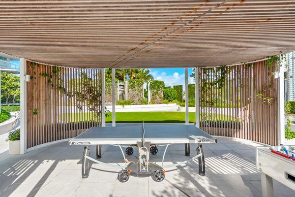 "Experience outdoor fun in style! This luxury Miami house boasts a sleek ping pong table for guests. A perfect 5-star escape