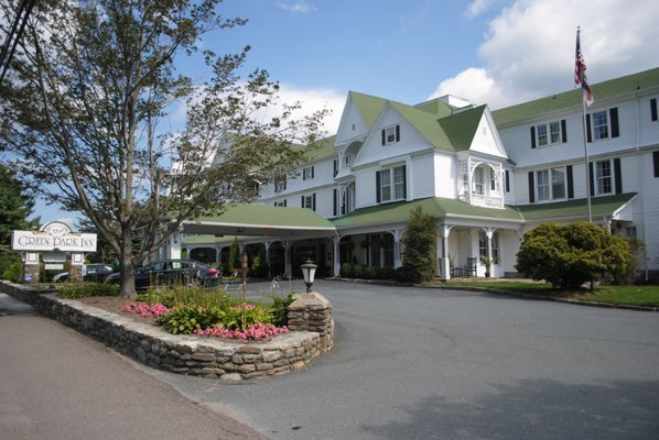 The big white wooden hotel with the green roof!