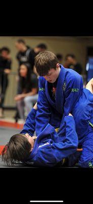 Cody pressing his opponent while in guard at 2019 Revolution BJJ Tournament