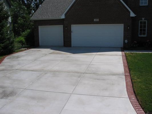 Concrete driveway with colored and stamped border done by LaMere