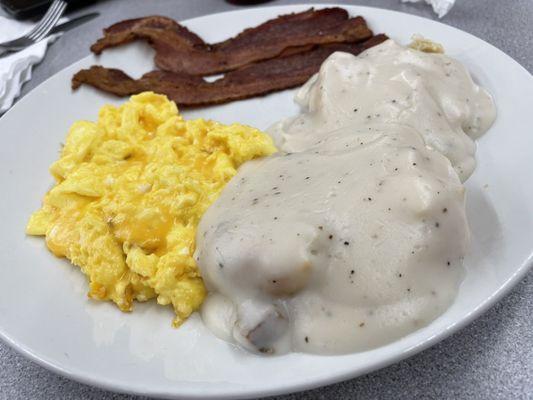 Breakfast. Scrambled eggs with cheese bacon and biscuits and gravy yum!