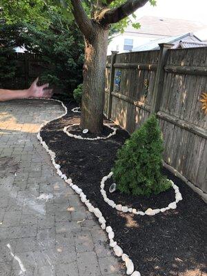 Beautiful landscaping with new black mulch and white Caribbean rocks