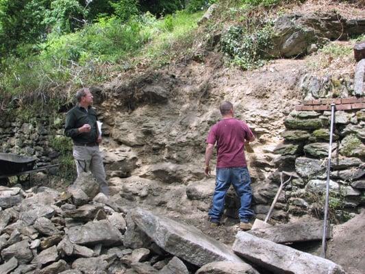 Rebuilding a dry laid stone wall.