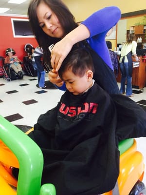 My Denon getting his haircut with his stylist. (Btw, she's the best with kids cut than the others...)