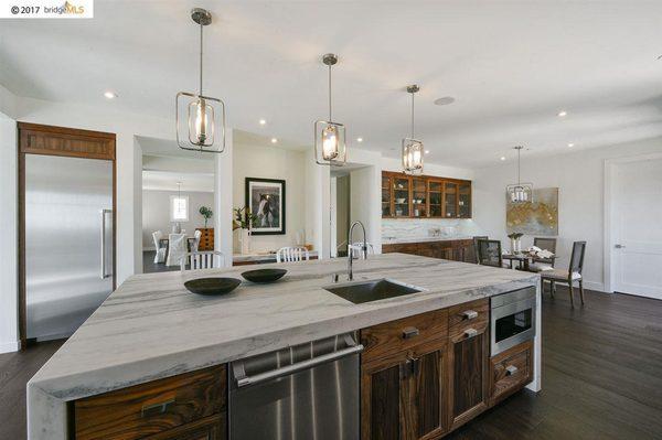 Kitchen: Full overlay, frameless Walnut Cabinetry with a clear conversion varnish "satin" sheen finish.