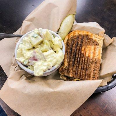 The Ruben Panini with a side of traditional potato salad.