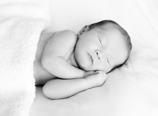 Sweet newborn baby boy in black and white