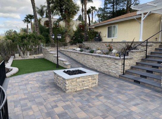 Fire pit Tuscan courtyard stone pavers with Alderwood ledgestone. Bullnose steps