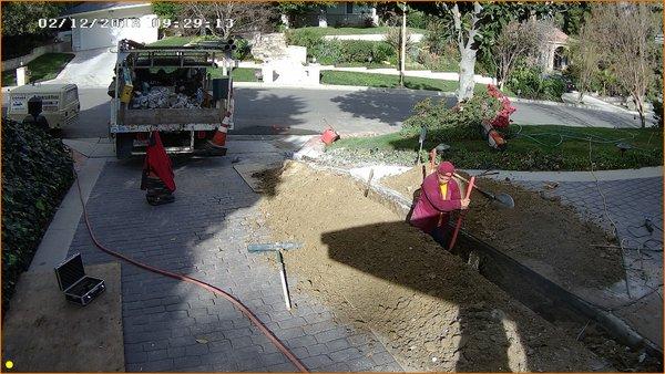 Precision dig by hand to insure no damage to driveway.