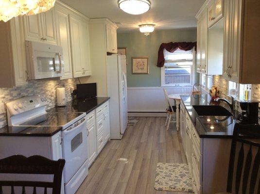 New floor, cabinets to the ceiling where soffit was, painted ceiling and walls, took out wall to make kitchen bigger!