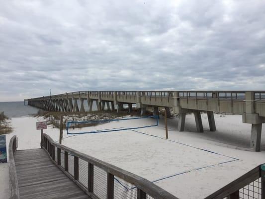 They are next to the long pier.