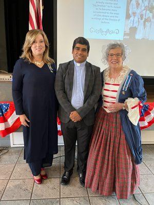 Tammy Strickland Real Estate Agent in Osyka Mississippi present flag pin to Priest for new citizenship celebration