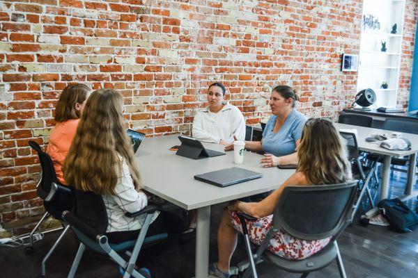 Team of attorneys and staff working collaboratively around a table