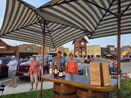 Outdoor bar set up by Winedown in Crosslake Town Square for a community event.