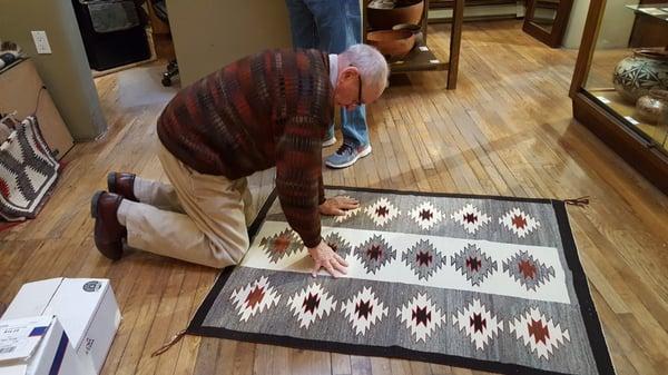 AL, the owner was inspecting a Navajo textile - rug when we were there.