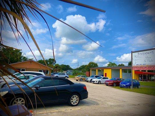 Parking, front of salon, car wash to the right.