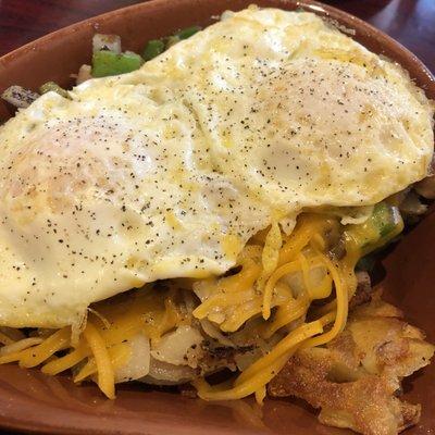 Sausage skillet with over easy eggs- American  fries (sliced potatoes), green peppers, onions and cheddar cheese