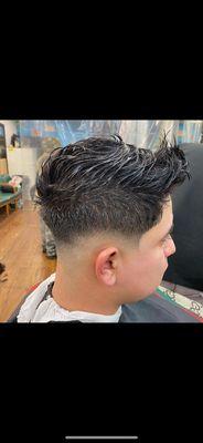 Low skin fade with spikes.