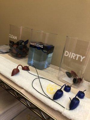 The sanitation buckets they let clients put there own goggles in (5 inches apart from each other)